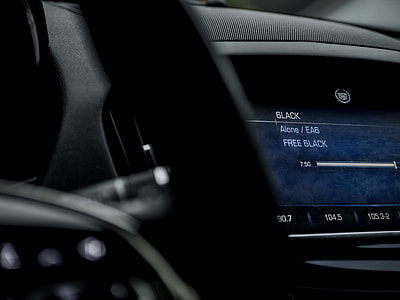selective focus photo of Cadillac 2-DIN vehicle stereo turned on thumbnail