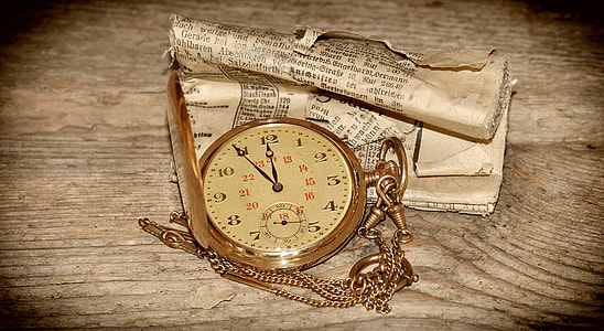gold pendant clock beside paper thumbnail