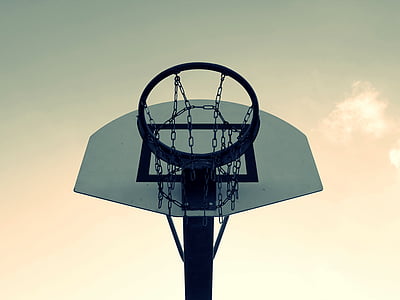 black and white basketball hoop under gray sky thumbnail