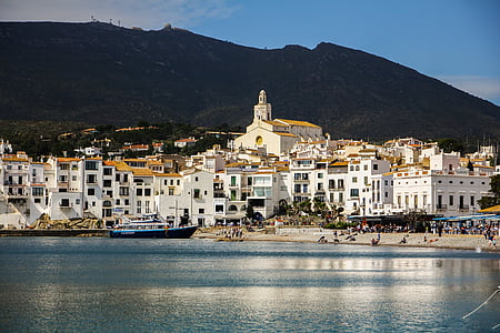 white and yellow villages near body of water thumbnail