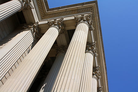 worms eye view of white concrete pillars during daytime thumbnail