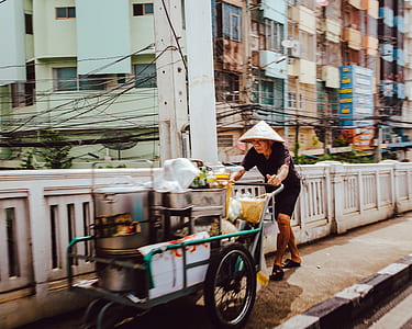 man pushing food cart thumbnail