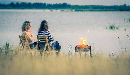 two women sitting on chair near grill thumbnail