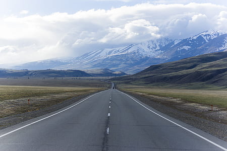 road in the middle of fields and mountain thumbnail
