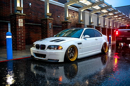 white BMW sedan parked on road thumbnail