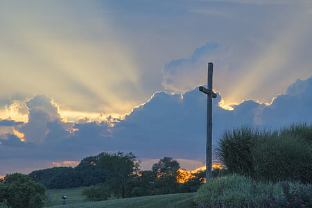 Big Wooden Cross On Green Grass Field Under The White Clouds thumbnail