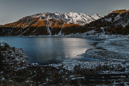 Brown and White High Rise Mountain Beside of Body of Water thumbnail