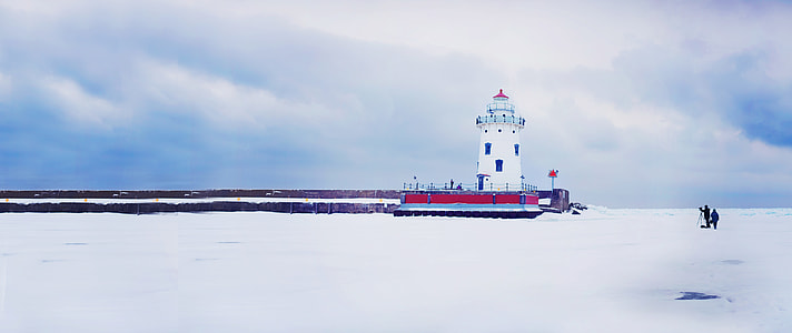white concrete lighthouse  with large body of water during daytime thumbnail