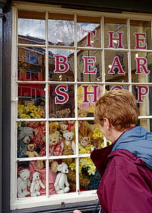 man looking at window filled with plush toys thumbnail