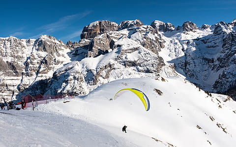 man riding parachute near snowfield thumbnail