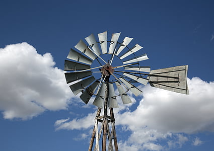 gray windmill under white clouds and blue sky thumbnail