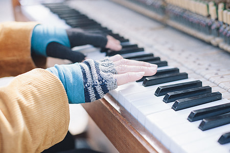 selective focus photography of person playing piano thumbnail