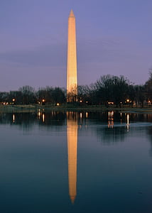 brown concrete tower near body of water during nighttime thumbnail
