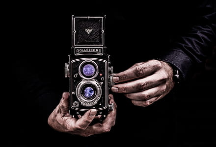 Person Holding Black Twin-lens Reflex Camera thumbnail