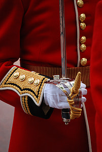 close up photo of man in red outfit holding sword thumbnail