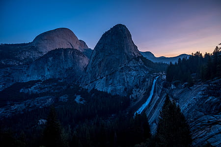 grey mountains near trees during daytime thumbnail