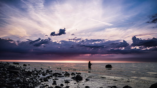 silhouette of person on body of water thumbnail