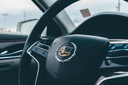 black Cadillac steering wheel during daytime thumbnail