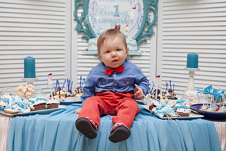 child in blue dress shirt and red pants thumbnail