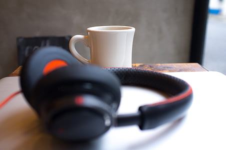 black headphones near white ceramic mug thumbnail