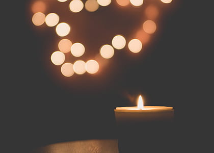 bokeh photography of lighted candle thumbnail