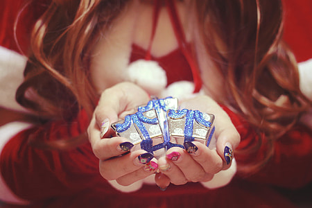 woman holding gray and blue gift box miniatures thumbnail