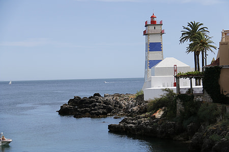 lighthouse beside body of water thumbnail