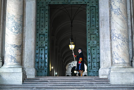 person holding light near pillars thumbnail