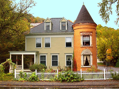 photo of brown and beige 3-story house between trees thumbnail