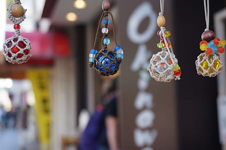 selective focus photography of four bead pendants thumbnail