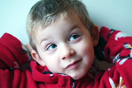 selective focus photography of boy in red hoodie grinning thumbnail