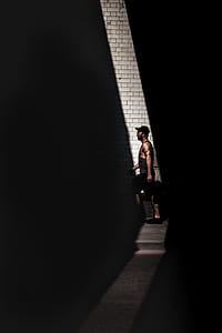 man standing beside wall thumbnail