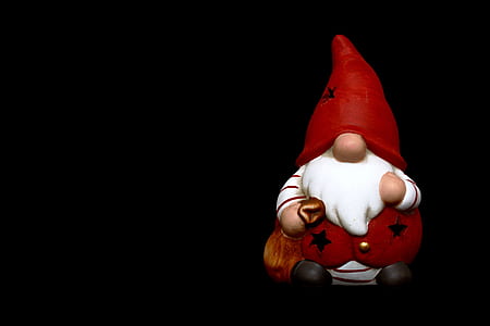dwarf figurine on black surface thumbnail