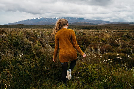 woman standing on grass field thumbnail