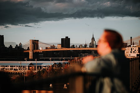 man standing in front of fence near Brooklyn Bridge thumbnail