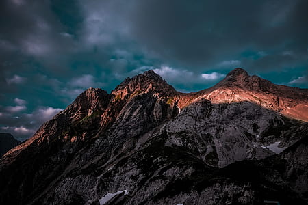brown mountains under gray clouds thumbnail