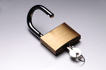 silver key inside brown pad lock thumbnail