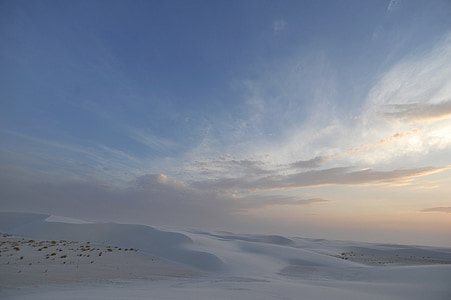 snow field under cloudy blue sky during daytime thumbnail