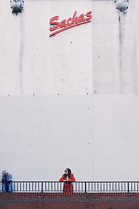 woman leaning on steel hand rails thumbnail