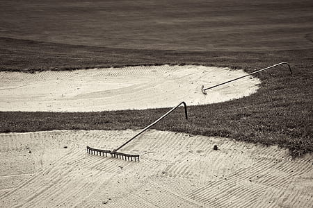 gray metal rake on white sand thumbnail