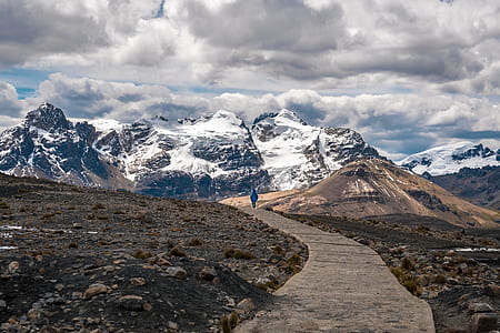 view of person walking on mountains path thumbnail