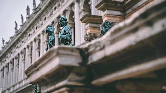 selective focus photography of two blue statues thumbnail