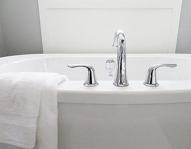 white bath towel on top of bathtub thumbnail