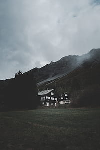 black and white concrete house near mountain thumbnail