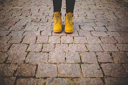 woman standing on gray brick flooring thumbnail