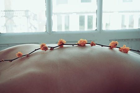orange flowers on person's body thumbnail