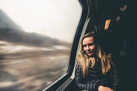 woman looking at plane's window thumbnail