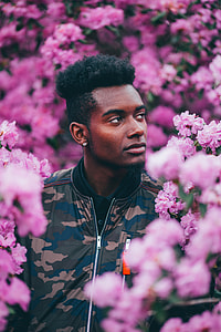 man looking at pink flowers thumbnail