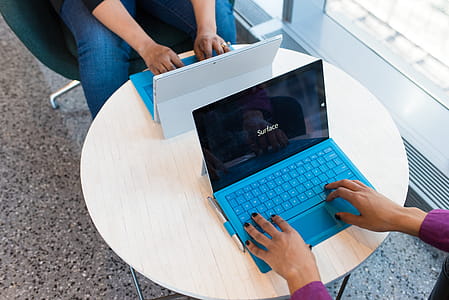 Two Black-and-blue Laptop Computers on White Table thumbnail