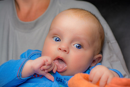 person in gray carrying baby thumbnail